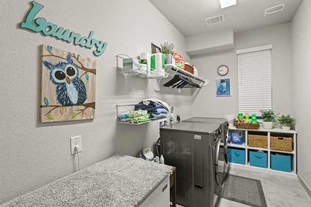 clothes washing area featuring independent washer and dryer