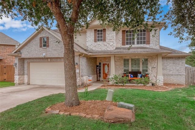 view of front of house with covered porch, a garage, and a front lawn