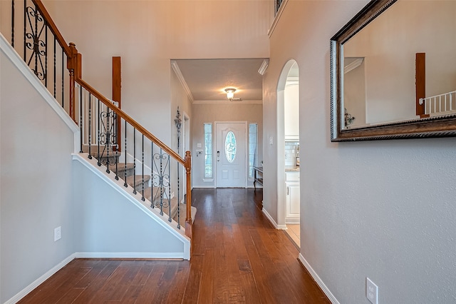 foyer entrance featuring ornamental molding and hardwood / wood-style flooring