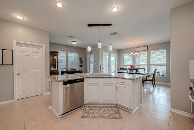 kitchen featuring white cabinets, a kitchen island with sink, light stone countertops, dishwasher, and sink