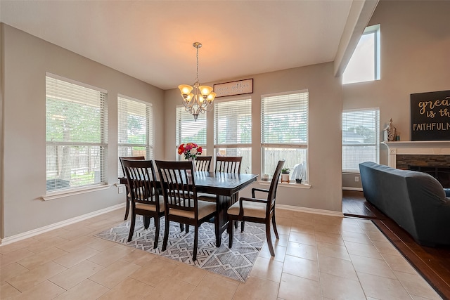 dining area featuring a chandelier and light tile patterned flooring