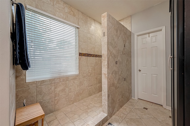 bathroom featuring a tile shower and tile patterned flooring