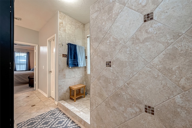 bathroom with tile walls and tile patterned flooring