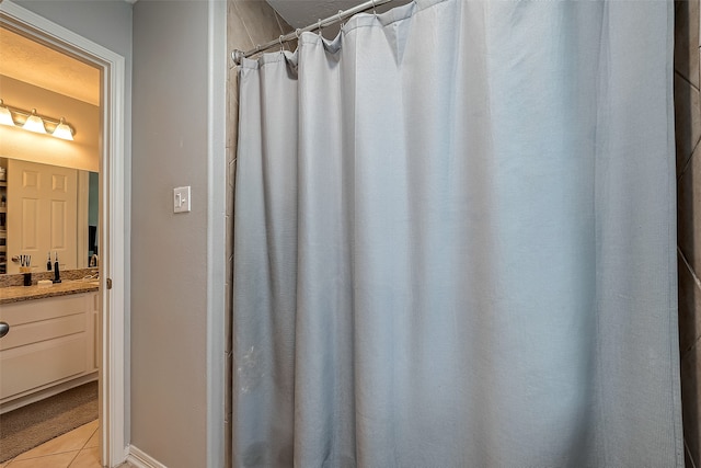 bathroom featuring vanity, tile patterned flooring, and a shower with shower curtain