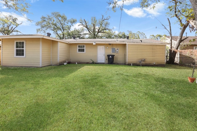 back of house with a yard