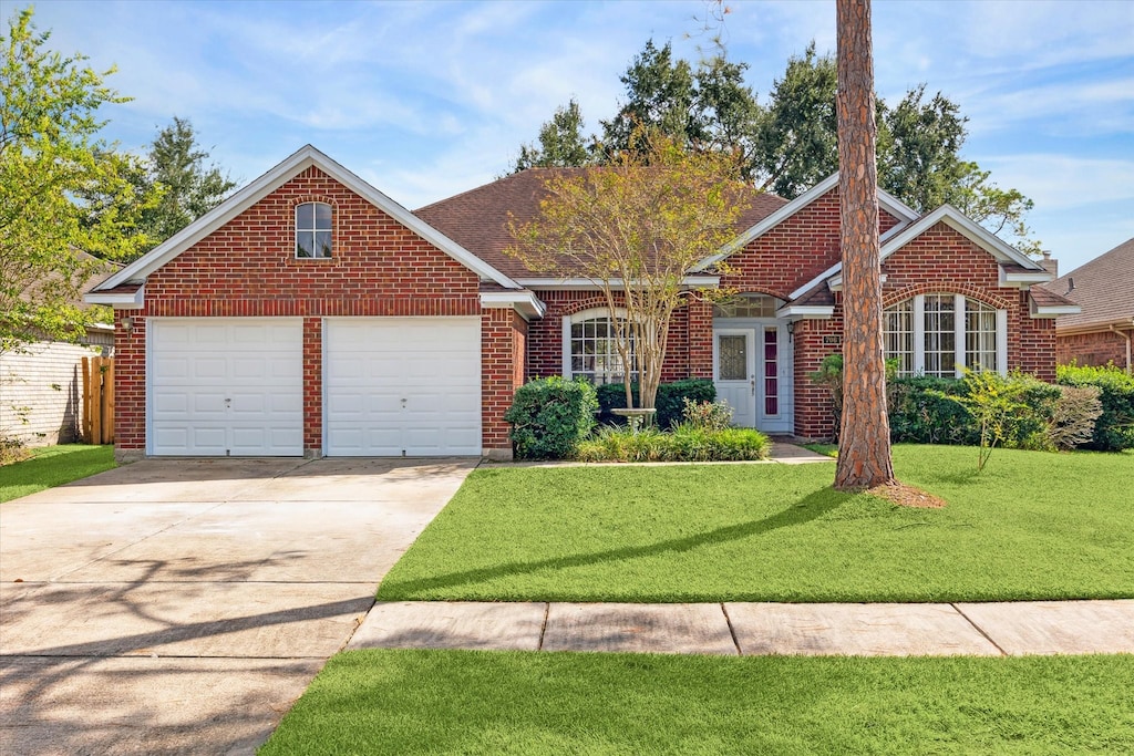 view of front of property with a front lawn and a garage