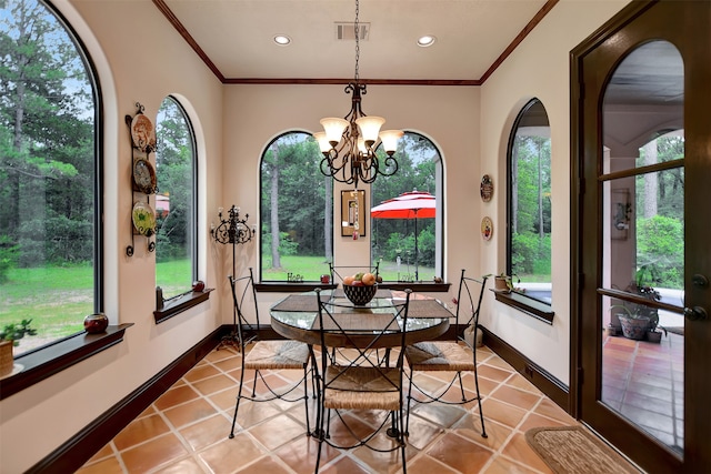 sunroom / solarium with an inviting chandelier