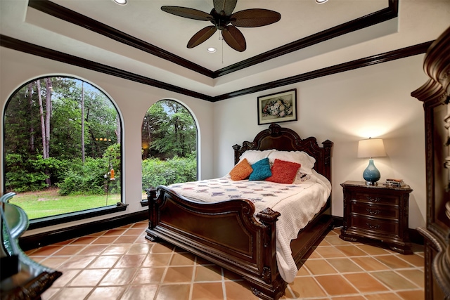 bedroom featuring ornamental molding, light tile patterned flooring, a tray ceiling, and ceiling fan