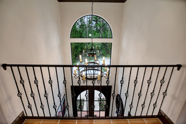 stairway with a chandelier