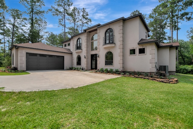 view of front facade featuring a front yard, a garage, and cooling unit