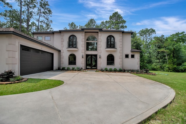 view of front of property with a front lawn and a garage