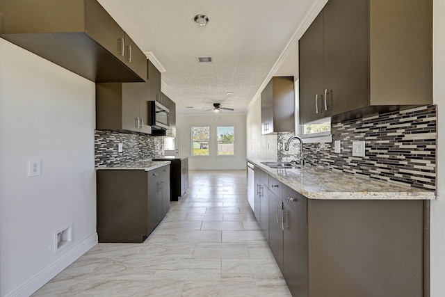 kitchen with appliances with stainless steel finishes, sink, a textured ceiling, ceiling fan, and decorative backsplash