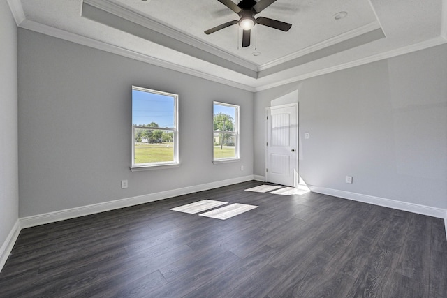 unfurnished room featuring dark wood-type flooring, crown molding, a tray ceiling, and ceiling fan