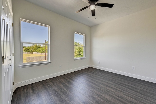 spare room with a textured ceiling, dark wood-type flooring, and ceiling fan