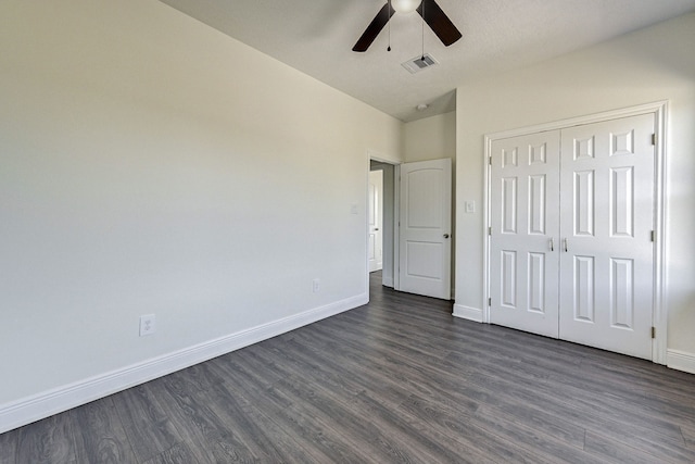 unfurnished bedroom with a closet, dark hardwood / wood-style floors, a textured ceiling, and ceiling fan