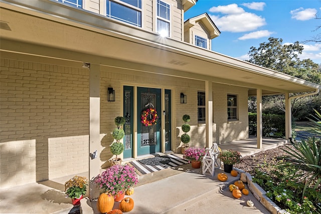 view of exterior entry with a porch