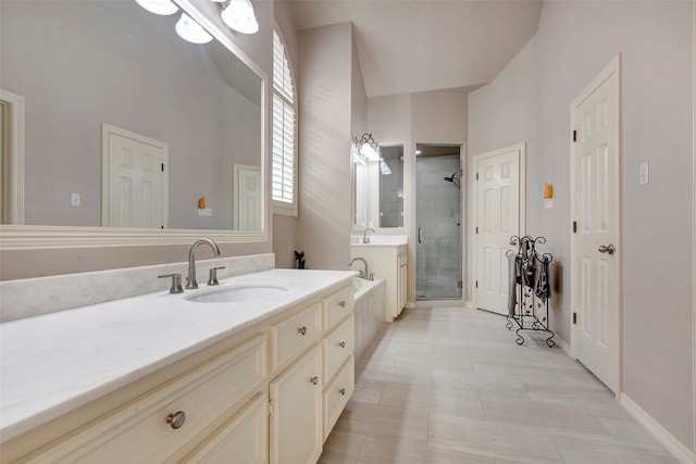 bathroom featuring tile patterned floors, vanity, and shower with separate bathtub