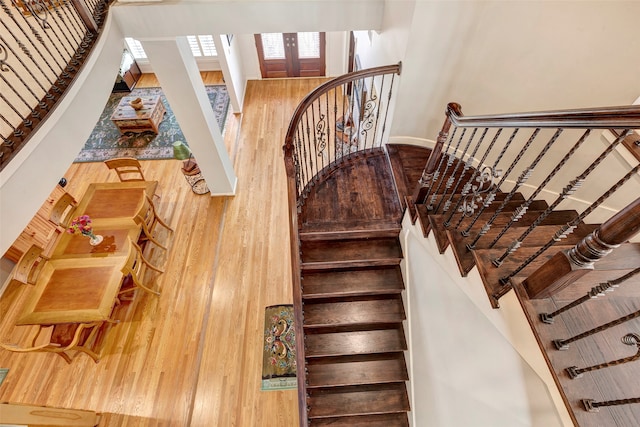 staircase featuring wood-type flooring and french doors