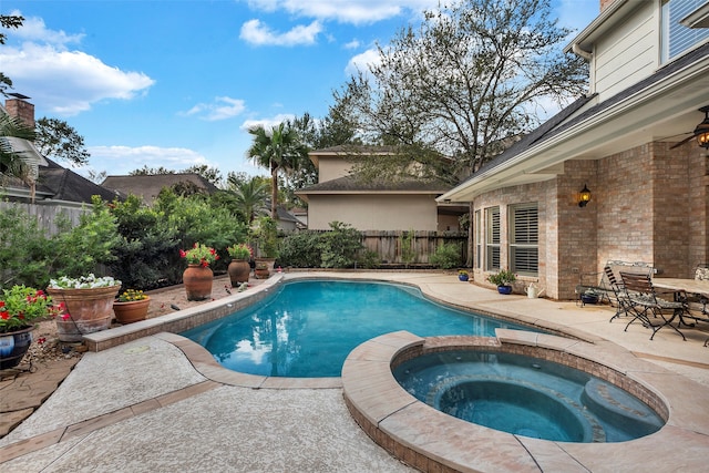 view of swimming pool with an in ground hot tub and a patio