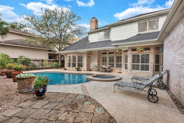 view of swimming pool with a patio area and an in ground hot tub