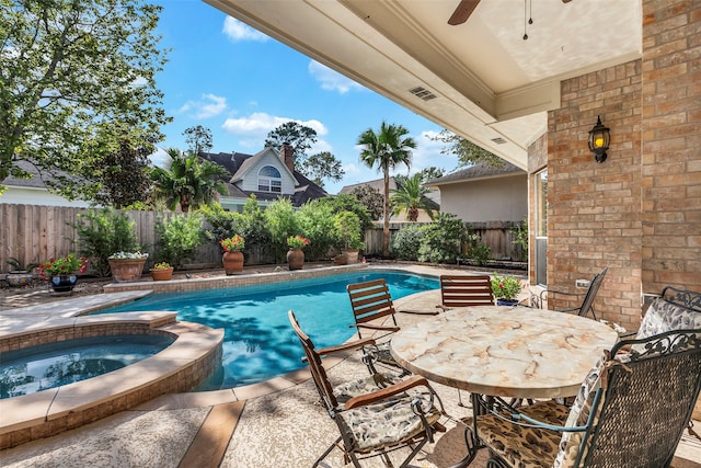 view of pool with an in ground hot tub and a patio