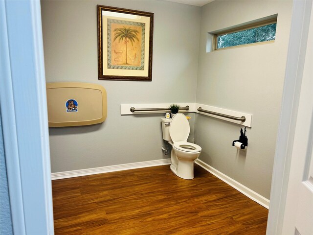 bathroom with hardwood / wood-style floors and toilet