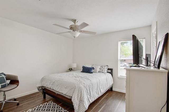 bedroom with ceiling fan and dark hardwood / wood-style flooring