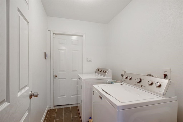 laundry area with dark hardwood / wood-style floors and washing machine and clothes dryer