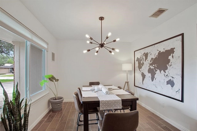 dining space with an inviting chandelier and dark hardwood / wood-style flooring