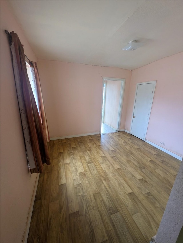 unfurnished room with light hardwood / wood-style floors