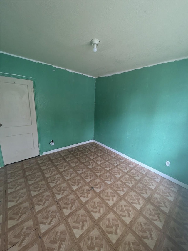 spare room featuring parquet floors