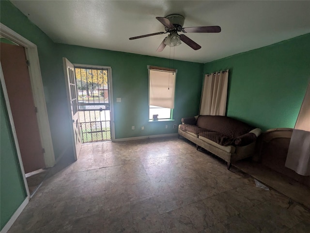 living room with a wealth of natural light and ceiling fan