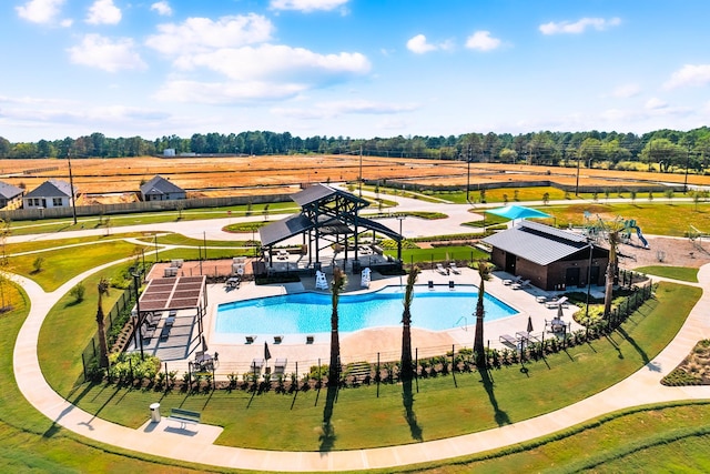 community pool featuring a patio and fence