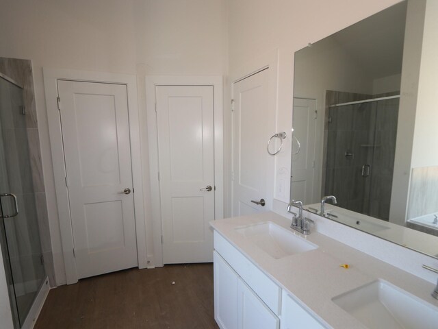 bathroom featuring vanity, hardwood / wood-style floors, and a shower with shower door