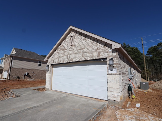 view of property exterior with a garage, an outdoor structure, and central AC unit