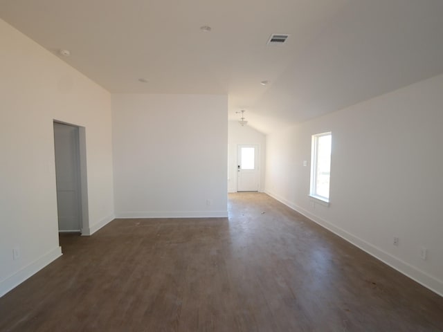 unfurnished room with dark wood-type flooring and lofted ceiling