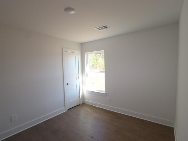 spare room featuring dark hardwood / wood-style flooring