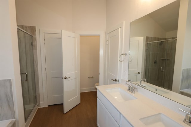 bathroom featuring a stall shower and a sink