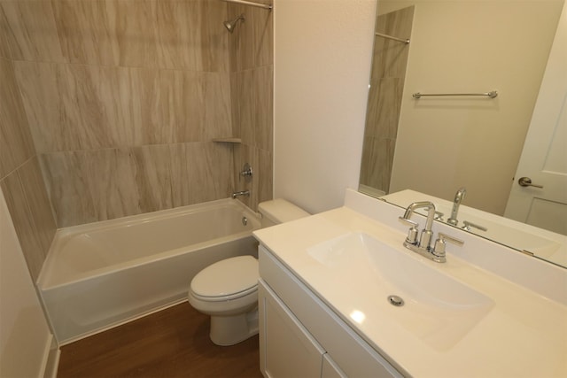 bathroom with vanity, shower / bath combination, wood finished floors, and toilet