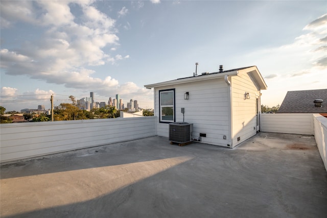 rear view of property with a patio area and central AC