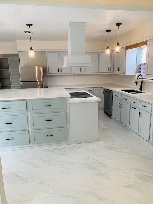 kitchen featuring sink, premium range hood, appliances with stainless steel finishes, and hanging light fixtures