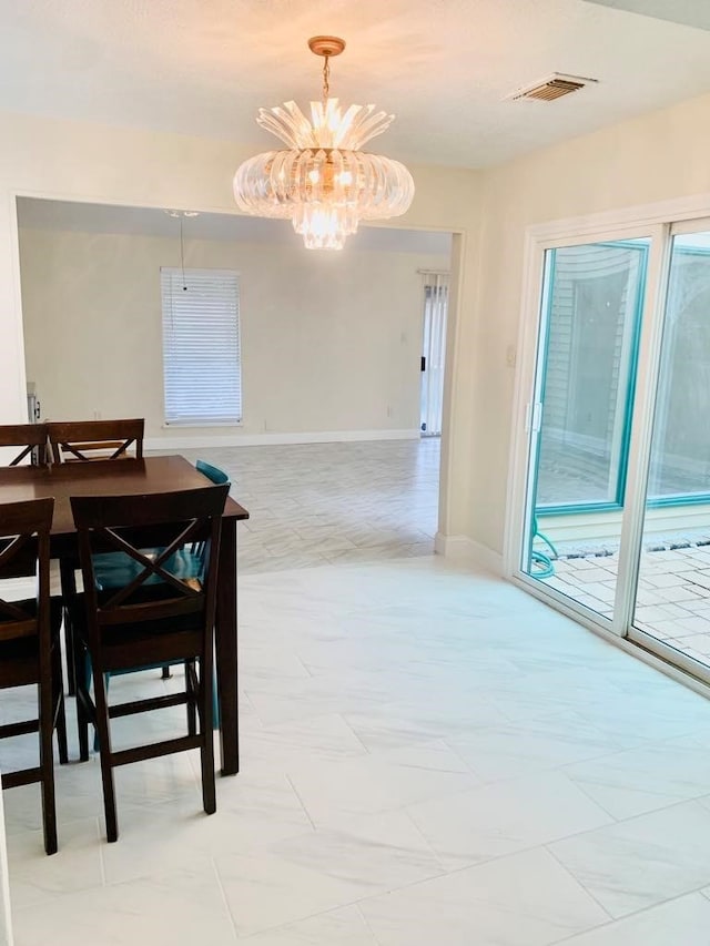 dining area featuring a notable chandelier