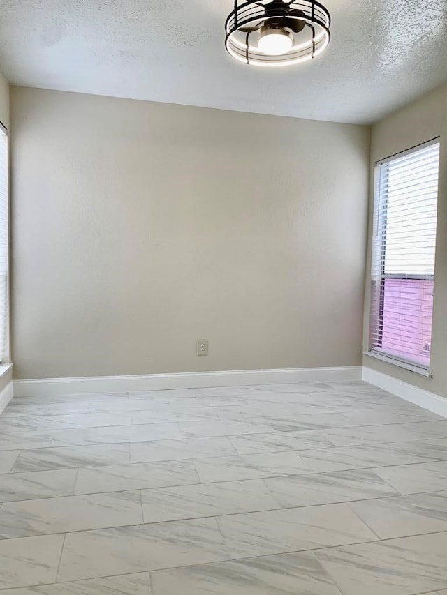 spare room featuring a textured ceiling