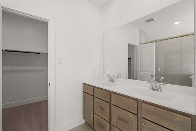 bathroom featuring vanity and a shower with shower door