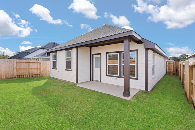 back of house with a lawn and a patio area