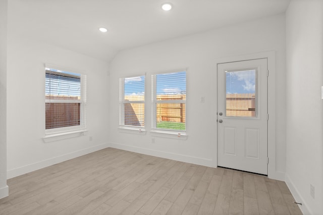 foyer featuring light hardwood / wood-style floors and lofted ceiling