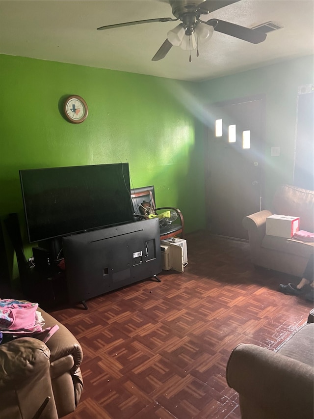 living room featuring dark parquet floors and ceiling fan