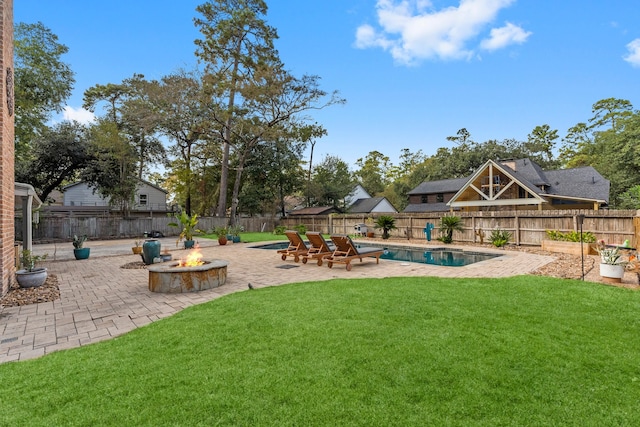 view of yard featuring a patio, a fenced in pool, and an outdoor fire pit