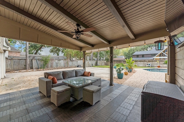 view of patio / terrace with a fenced in pool and ceiling fan