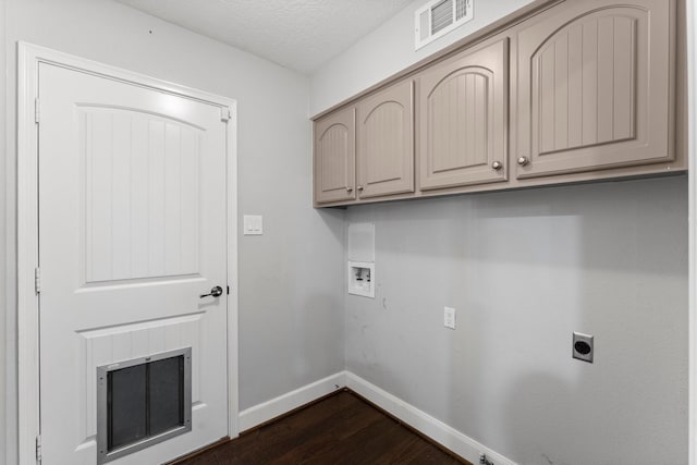 clothes washing area featuring cabinets, hookup for a washing machine, a textured ceiling, electric dryer hookup, and dark hardwood / wood-style floors